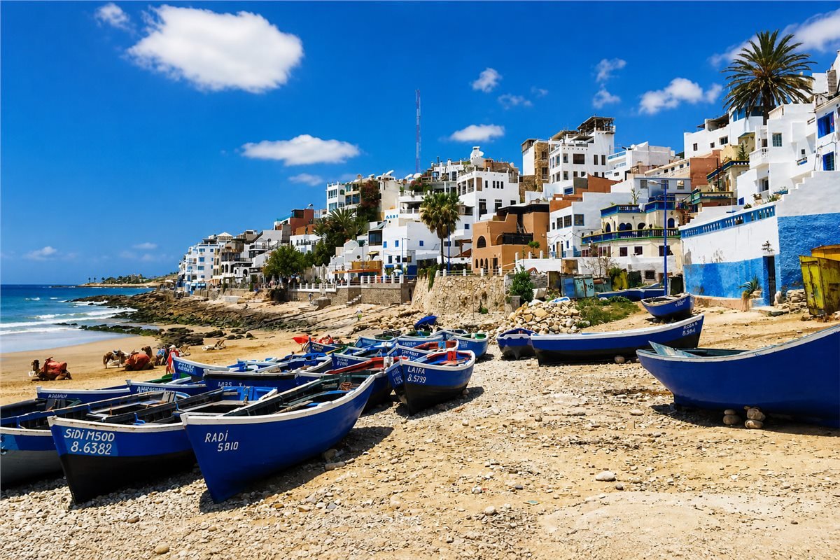Blue fishing boats and white coastal houses south of Agadir