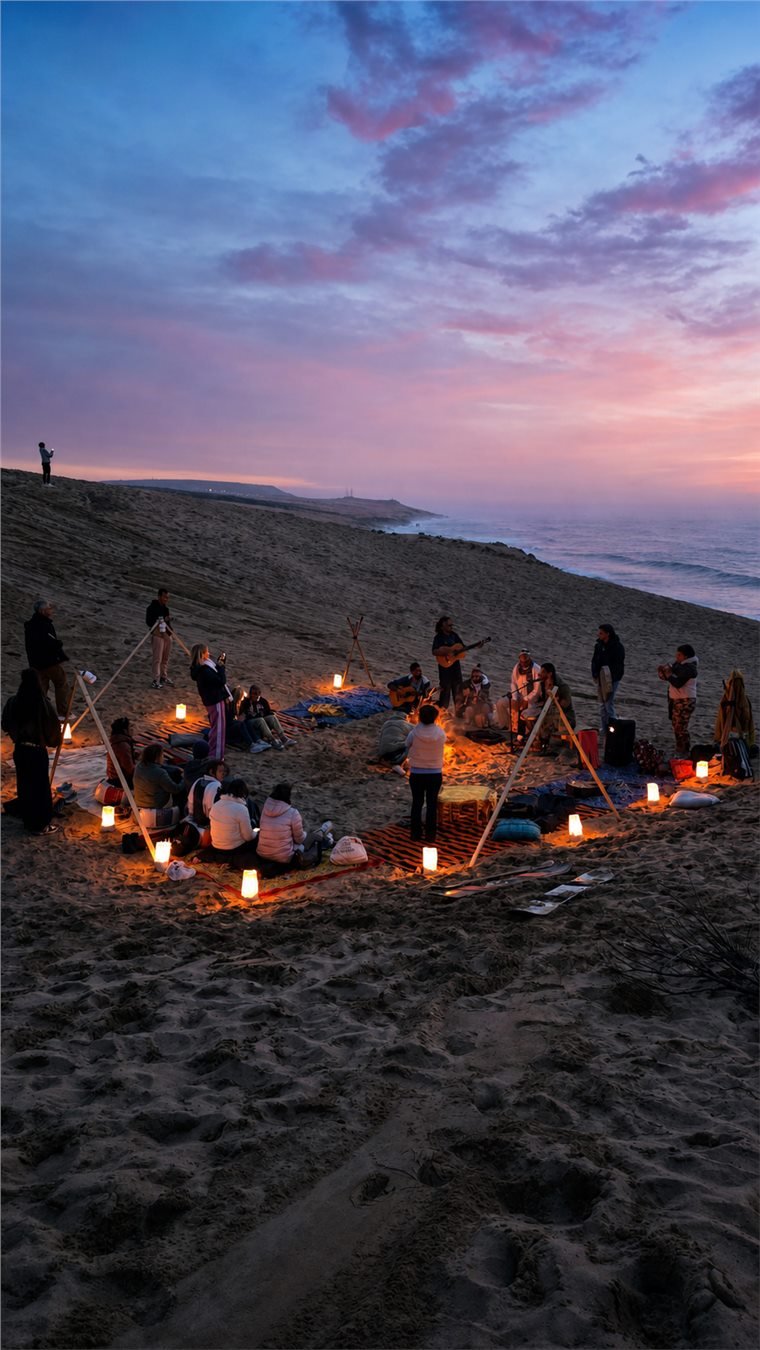 Evening group gathering with lanterns on the Timlaline dunes