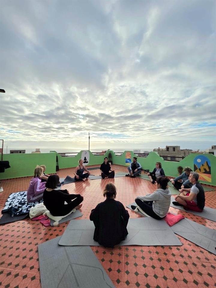 Yoga class on Dar Mouja rooftop terrace at sunrise