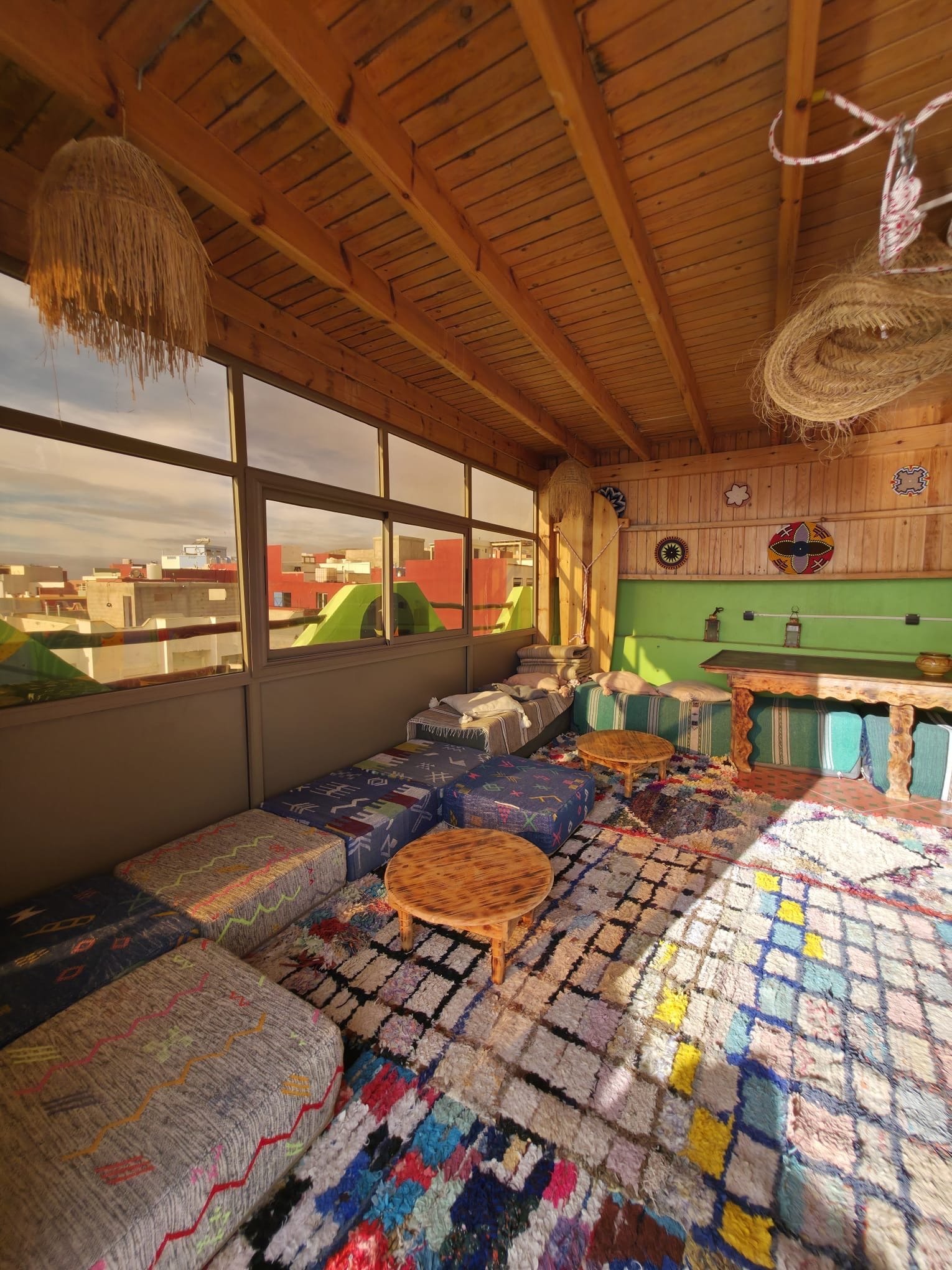 Panoramic lounge with wooden beams at Dar Mouja